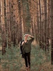 Stylish young woman posing in nature in street style clothing.