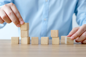 Man hands holding blank wooden cubes on table background, mock up, template, banner with copy space for text