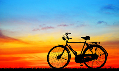 Naklejka na ściany i meble silhouette vintage bike on sunrise