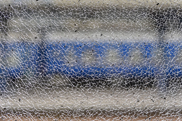 Broken glass and on rear blur background railway station with wagons of train