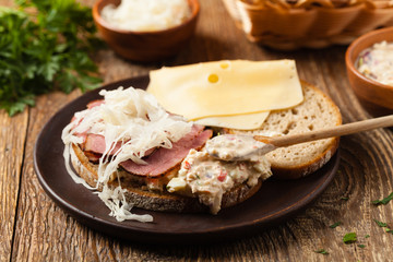 Ruben sandwich. New York sandwich with pastrami, sauce 1000 islands and sauerkraut.