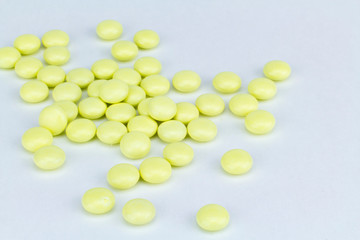 yellow pills on white background