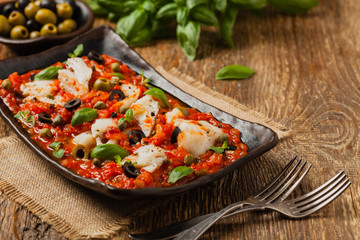 Cod in Italian in tomatoes with olives and capers.