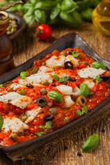 Cod in Italian in tomatoes with olives and capers.