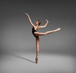 Beautiful flexible ballerina dancing in studio - obrazy, fototapety, plakaty
