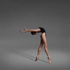 Beautiful flexible ballerina dancing in studio - obrazy, fototapety, plakaty