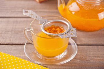 Sea buckthorn tea in a glass cup. Herbal vitamin tea.
