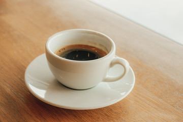 Cup of coffee cappuccino on wooden bar in cafe.