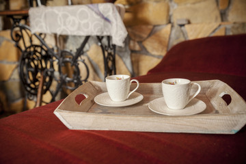 Obraz premium two antique cups of coffee on the old tray