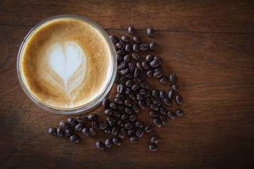 coffee cup and coffee beans on old wooden background, Top view