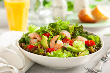 Fresh summer salad with shrimp, avocado and tomato