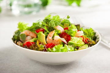 Fresh summer salad with shrimp, avocado and tomato