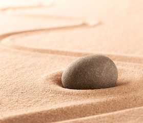 Fototapeta na wymiar Spa wellness or mindfulness stone and sand garden. Concentration or focus point for spiritual balance and purity of mind and soul. Sandy background with copy space. .