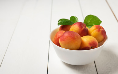 sweet delicious apricot on dark bowl white wood table summer fresh fruit