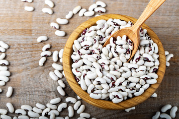 Raw beans in a wooden bowl