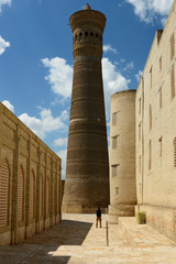 The tourist is making the photograph of the Kalyan minaret in Bukhara, Uzbekistan.