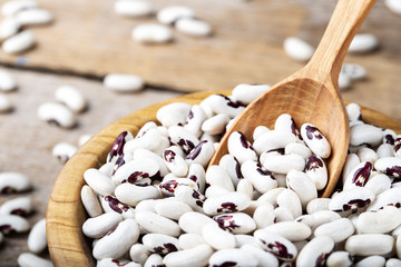 Raw beans in a wooden bowl