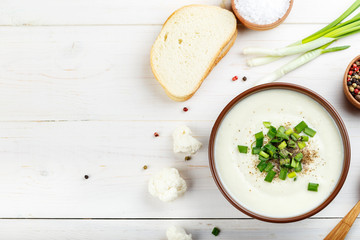 Potato cauliflower soup puree on a white background, top view.