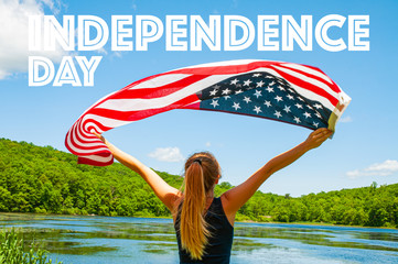 Happy Independence Day, 4th of July. Woman holding American flag on lake background.