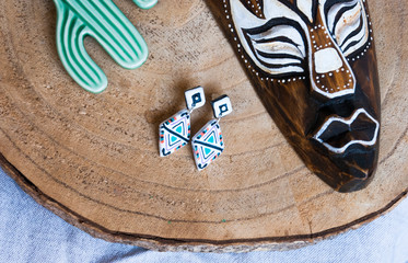 Mexican jewelry flat lay with mask and earrings.