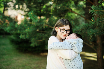 Older sister hugging newborn baby brother