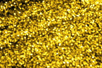 Gold bokeh with golden lights. Blurred glare background. Beautiful Card.