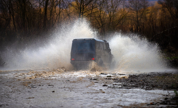 Off road. Suv splash on the river outdoor, traveling on the road. cene of mud splash in off-road racing. Stop action with high speed shutter.