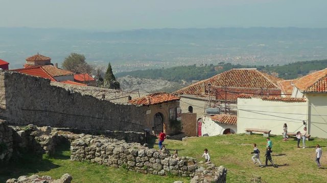 Children playing within the old castle in Kruja, Albania. Slow motion steadicam shot