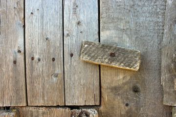 Old wooden lock with a nail in the middle of a close up. Weak password or protection. Easy to crack. QWERTY lock.