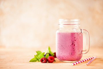 Delicious blackberry raspberry smoothie with mint and fresh berries in glasses. Selective focus.