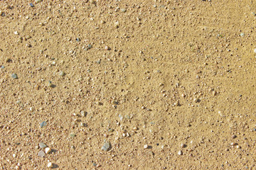Textured background of dirty coarse quarry sand.