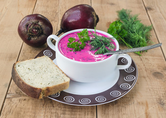 beet soup in bowl with bread