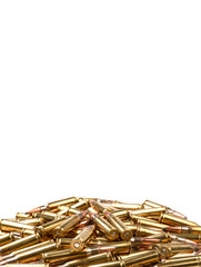 cartridges for 308 caliber rifle on a white background. a bunch of ammo. cartridges scattered on a light background