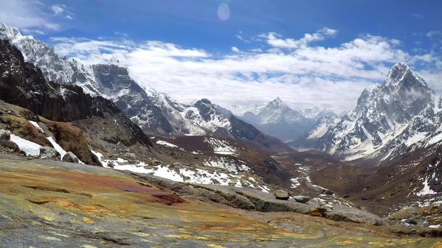 4K Time lapse of moving clouds above Chola Valley in Himalayan mountains (Himalayas) with Mount Lobuche in the left, Mounts Cholatse and Tobuche in the right and Mount Ama Dablam in the middle.