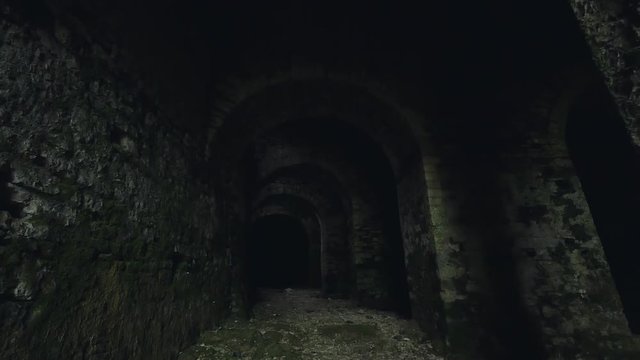 Dark stone dungeon in medieval castle. Steadicam shot
