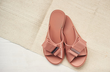 Fashionable summer sandals of coral color are ready for vacation, top view with place for copy-paste.
