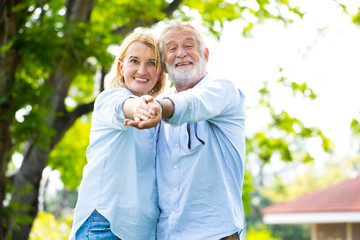 Portrait Happy Elderly couple dancei with happiness in the garden