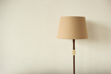 Lampshade on the background of an empty wall. Horizontal photo with place for writing.