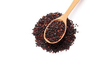 Black quinoa in a wooden spoon isolated on white background