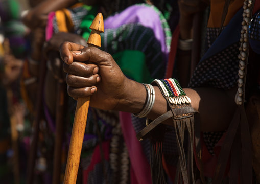 Woman holding a traditional stick with a phallic shape during the gada system ceremony in borana tribe, Oromia, Yabelo, Ethiopia