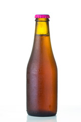 Bottle of beer with drops isolated on white background
