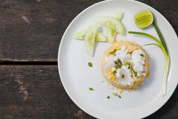 Fried rice with Squid on the wooden table from top view