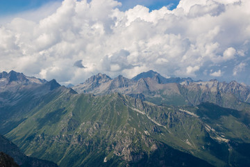 Fototapeta premium Panorama of mountains scene with dramatic cloudy sky in national park of Dombay