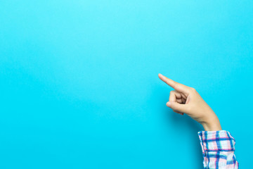 Person pointing at something on a blue background