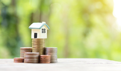 Miniature colorful house on stack coins using as property and finance concept
