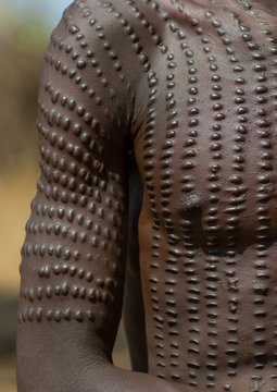 Topossa man with scarifications on his body, Kangate, Omo valley, Ethiopia