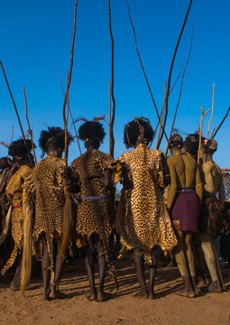 Dassanech men with leopard skins and ostrich feathers headwears during dimi ceremony to celebrate circumcision of teenagers, Omorate, Ethiopia