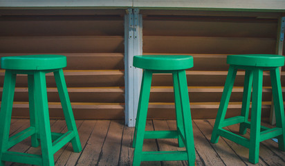 Three-green chairs stand nearby