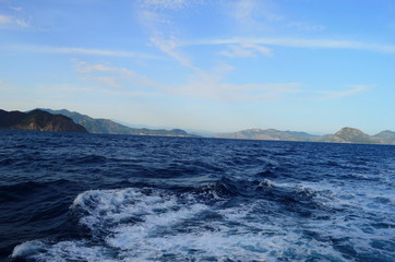 the setting sun in the clouds over the Aegean Sea