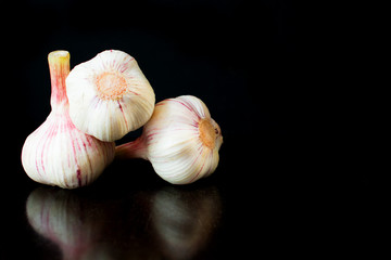 Garlic bulbs, on black background.Copy space
